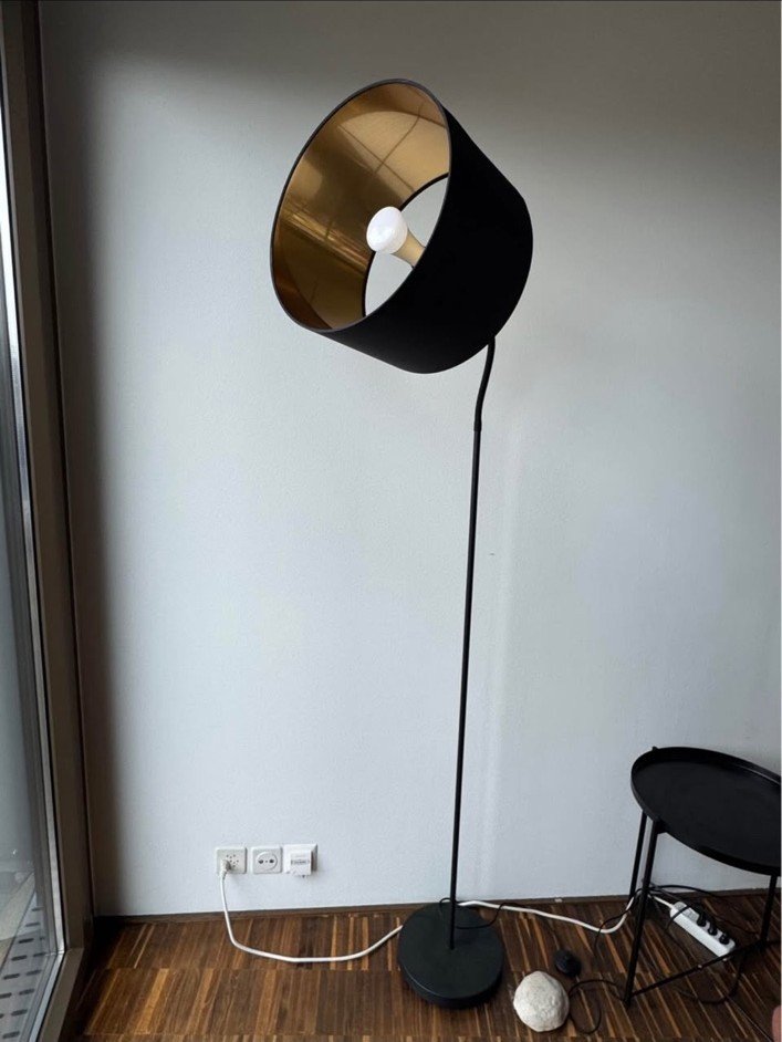 Stehlampe Schwarz & Gold · Licht unter dem schwarzen Hut · Lampe · Schwarzer Schirm mit goldfarbener Innenseite · genaue Materialien nicht bekannt · Höhe, Fuss- und Schirmdurchmesser auf Anfrage · Foto 1